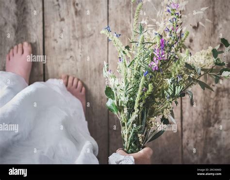 girls hand holding picking wild flowers Stock Photo - Alamy