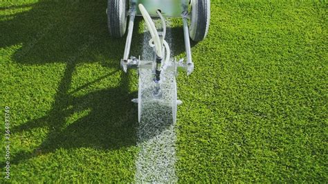 Marking football stadium field using a professional paint machine Stock Photo | Adobe Stock