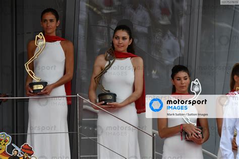 The trophies being held by models prior to distribution on the podium ...