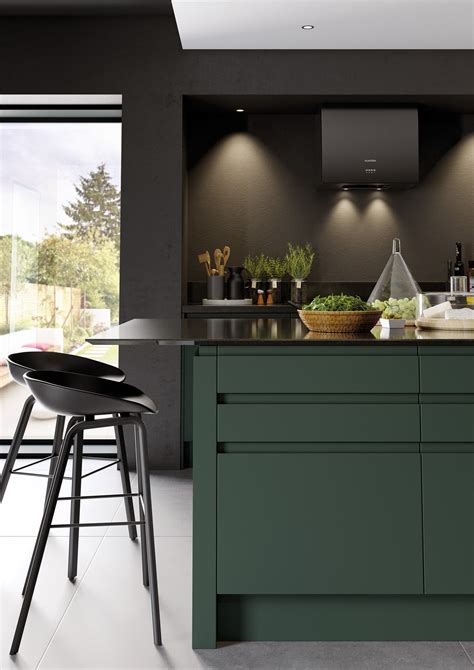 Dark Forest Green handleless kitchen with dark walls and dark quartz work surfaces. It's bold ...