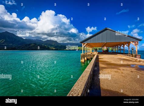 Hanalei Pier with tropical green water under blue sky, Hanalei Bay ...