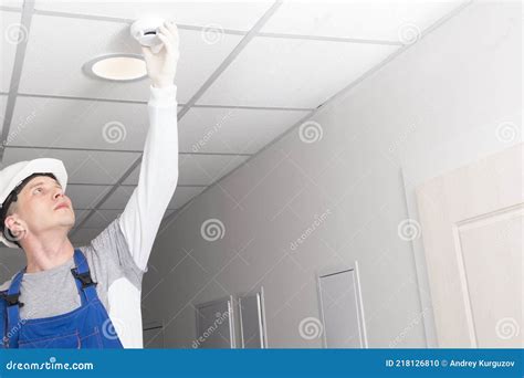 A Worker Installs a Fire Safety Sensor Stock Photo - Image of electrician, repair: 218126810