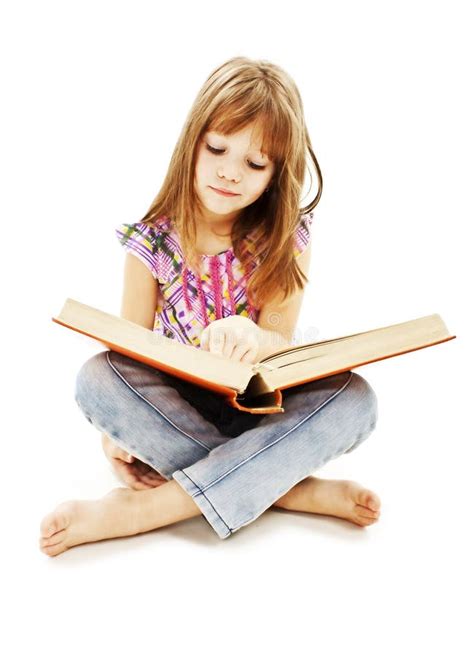 A Little Girl Reading A Book On The Floor Stock Photo - Image of beauty, beautiful: 21971820