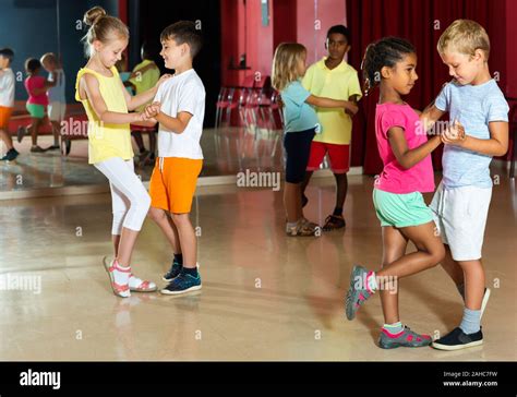 Group of kids dancing salsa dance in modern studio Stock Photo - Alamy