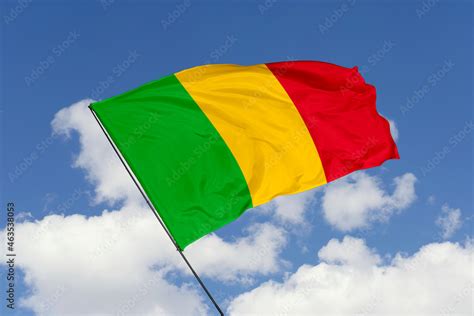 Mali flag isolated on the blue sky background. close up waving flag of ...