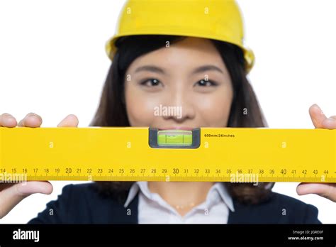 Smiling architect woman holding yellow ruler isolated on white Stock Photo - Alamy