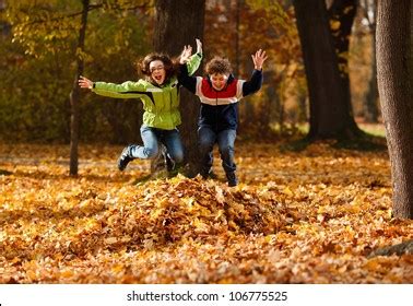 Kids Jumping Leaves Photos, Images and Pictures