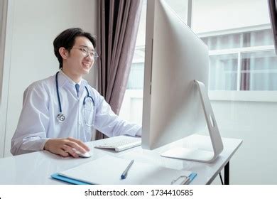 Doctor Wearing Stethoscope Working Tablet Smiling Stock Photo 1734410585 | Shutterstock