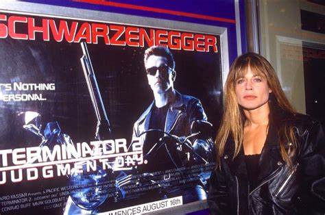 Linda Hamilton in front of a Terminator 2 advertisement, 1991. : OldSchoolCool