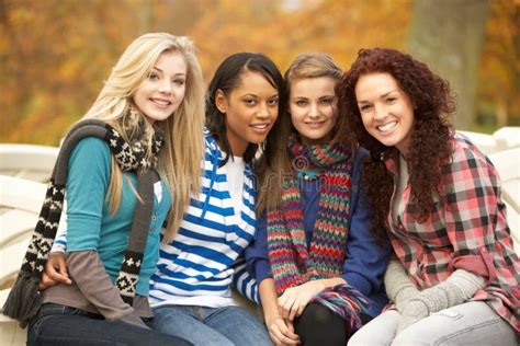 Group Of Four Teenage Girls Sitting On Bench Stock Images - Image: 13671364