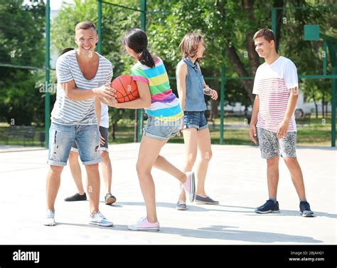 Teenagers playing basketball Stock Photo - Alamy