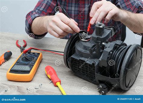 Vacuum Cleaner Repair. Small Business. Professional Technician Serviceman is Repairing Modern ...