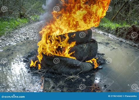 Burning tires on the road stock photo. Image of poison - 219614342