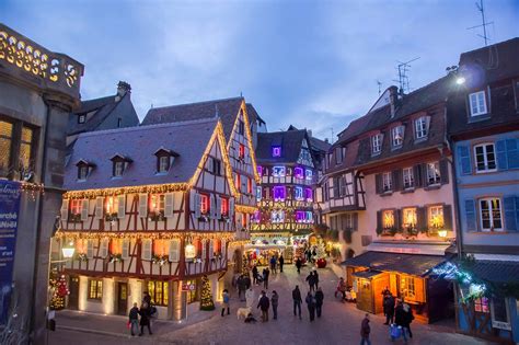 people are walking around an old european town at christmas time with ...