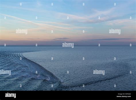 Wadden Sea, North Sea island Spiekeroog, ferry pulls a slight wave on the calm sea, at high tide ...