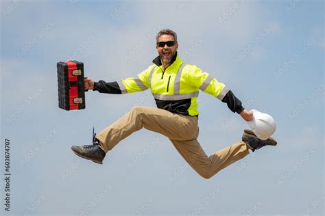 Fast building. Funny construction worker jumping. Excited jump of builders in helmet. Worker in ...