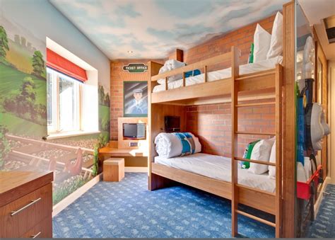 a bedroom with two bunk beds and a mural on the wall