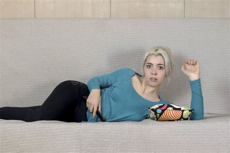 Beautiful Young Surprised Woman Watching TV at Home Alone Stock Photo ...