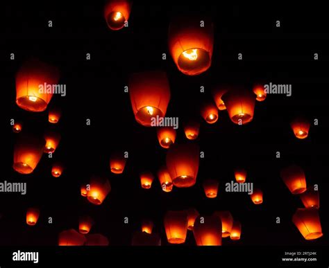 Glowing paper lanterns illuminate the night sky during the Pingxi sky ...