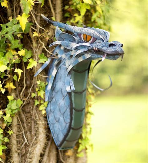 a blue dragon head on the side of a tree