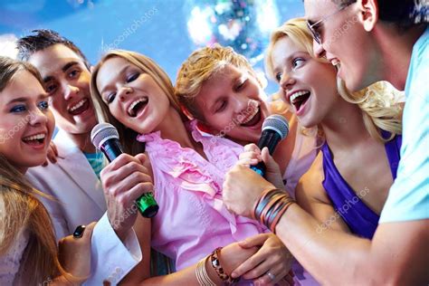 Friends singing at party — Stock Photo © pressmaster #47818953