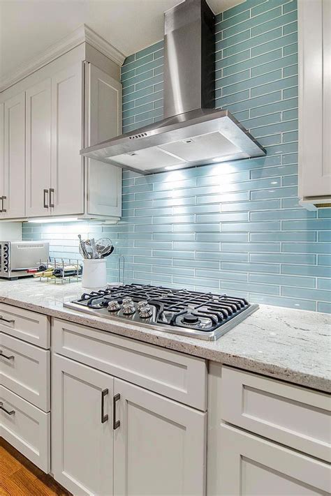 The reflective quality of this kitchen's blue glass tile backsplash is a perfect... | Blue glass ...