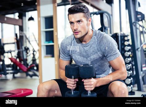 Portrait of a handsome fitness man workout with dumbbells in gym Stock ...