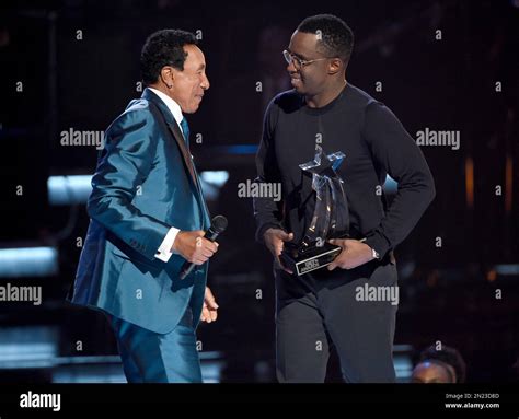 Sean “Diddy” Combs, right, presents the lifetime achievement award to ...