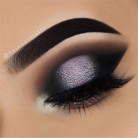 Dramatic modern smokey eye. Black dark eye shadow with silver glitter ...