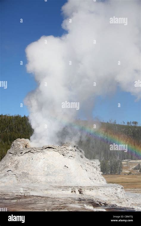 Castle Geyser eruption with rainbow, Upper Geyser Basin geothermal area ...