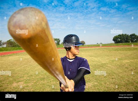 baseball player holding baseball bat Stock Photo - Alamy