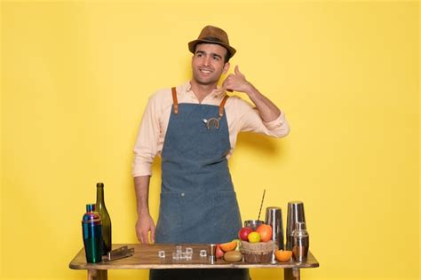 Free Photo | Front view male bartender standing in front of desk with drinks and fruits smiling ...