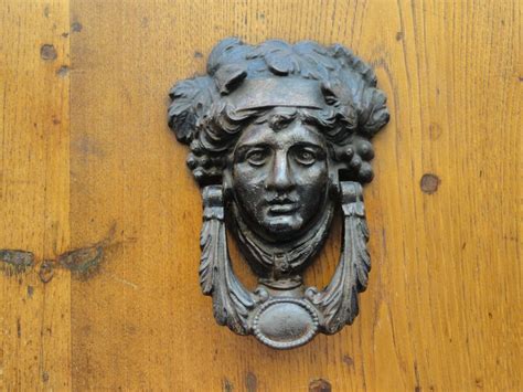 Doorway knocker on a wooden door close-up free image download