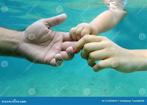 Human Hands in Underwater. Baby Hand Holding Fathers Finger Stock Image - Image of family, baby ...