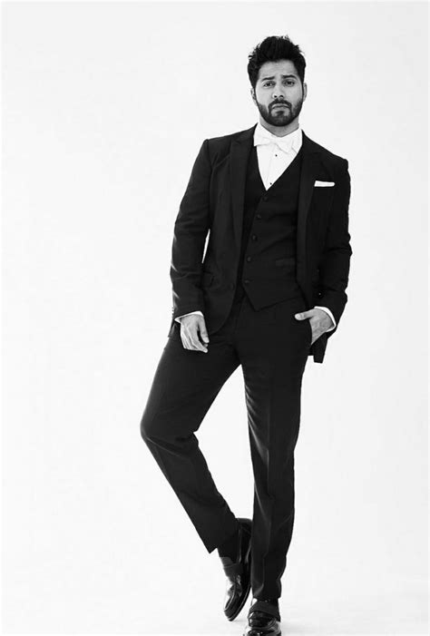 a man in a tuxedo is posing for a black and white photo with his hands ...