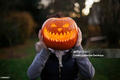 A Girl With Halloween Pumpkin In Front Of Her Head High-Res Stock Photo - Getty Images