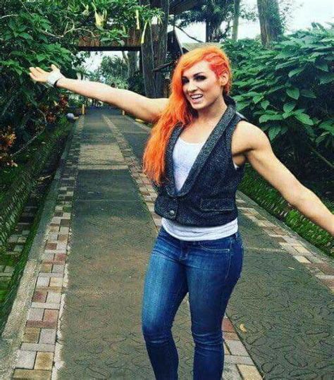 a woman with red hair and blue jeans is posing on a skateboard in the ...