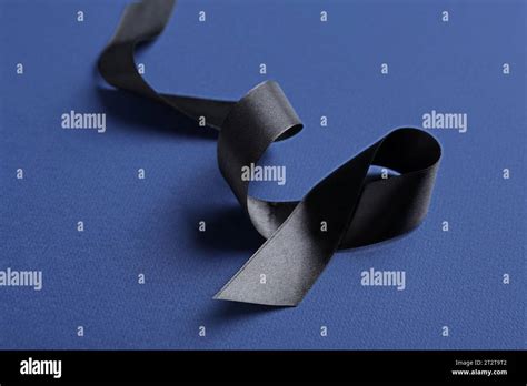 Black funeral ribbon on blue background Stock Photo - Alamy