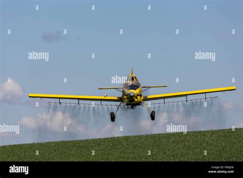 Crop duster plane flying and spraying over crops in the Palouse region ...