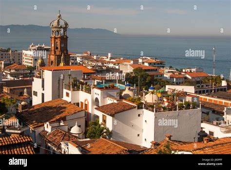 A rooftop view of down town Puerto Vallarta with the ornate tower of the cathedral as a focal ...