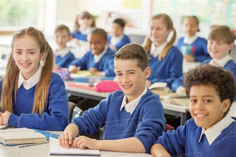 Elementary school children smiling in classroom - Stock Photo - Dissolve