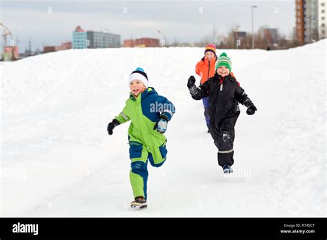 happy little kids playing outdoors in winter Stock Photo - Alamy