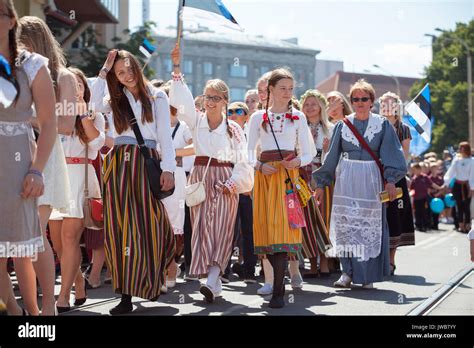 TALLINN, ESTONIA - 04 JUL 2014: People in Estonian costumes going at ceremonial procession of ...