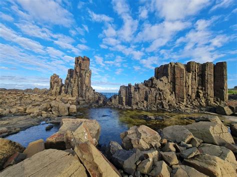 Rock Formations in Bombo Headland Quarry with a Cloudy Blue Sky in the Background, Australia ...