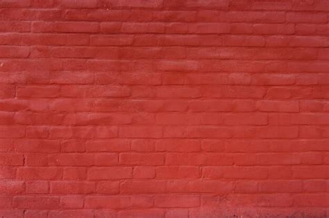 Premium Photo | Brick wall painted red for background or texture