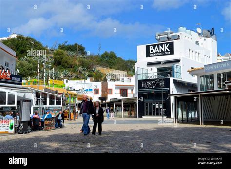 Tourists eating and drinking in restaurants in the old town of ...