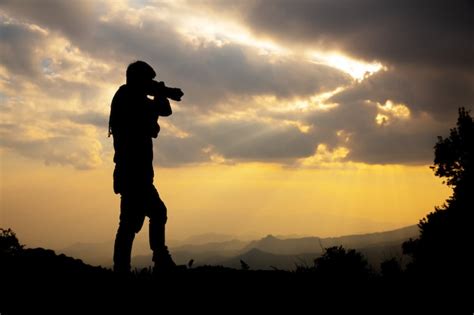 Free Photo | Silhouette of a photographer who shoots a sunset in the ...