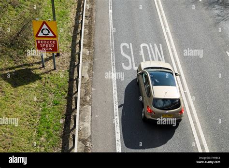 Slow down sign on road hi-res stock photography and images - Alamy