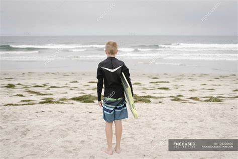 Boy standing on sandy beach — 1 Person, relationship - Stock Photo ...