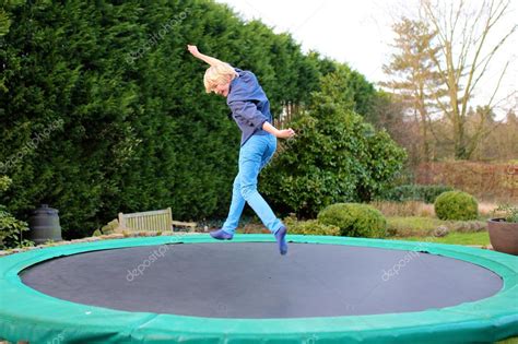 Happy boy jumping on trampoline — Stock Photo © CroMary #113827460